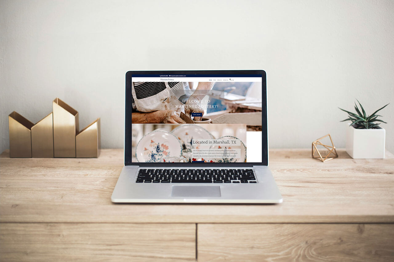 a laptop on a desk with a website on the screen